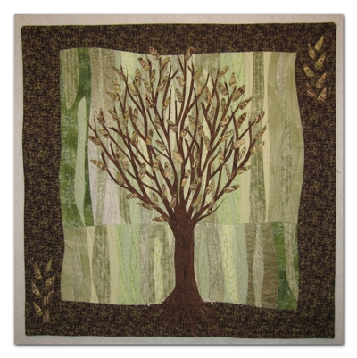 It took me awhile to be inspired by this year's Hoffman Challenge fabric. But finally, the idea for Woodland Spring surfaced. New leaves and blossoms are just appearing in the forest. I used my Lazy Landscape for the background and my Graceful Trees design. Hot fix pearls made the sweet little blossoms. Woodland Spring will travel in trunk QC-F.